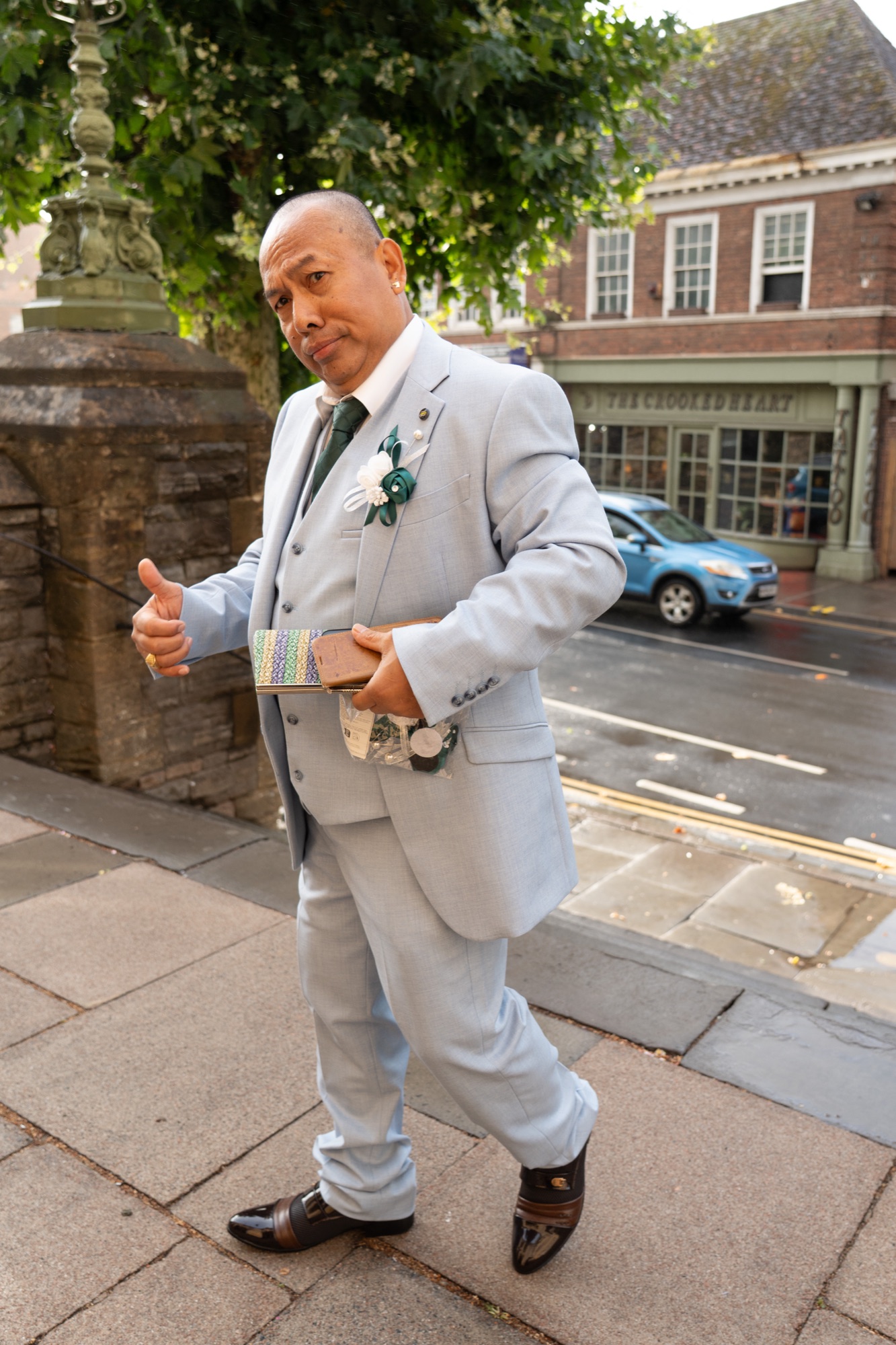 The groom hailing a cab on the way to the wedding