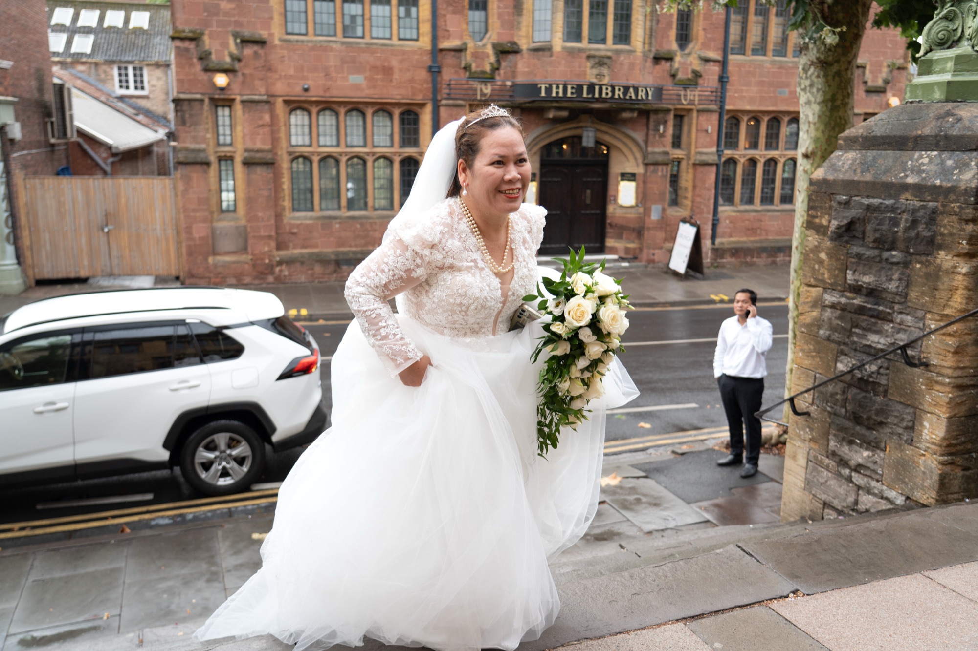 The bride arriving in her wedding dress