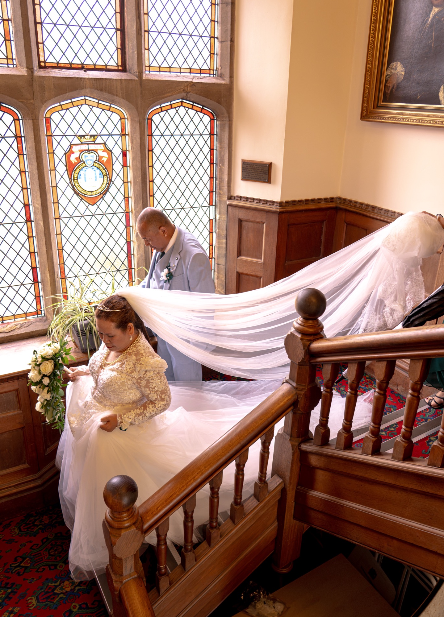 The groom arranging the bride's veil