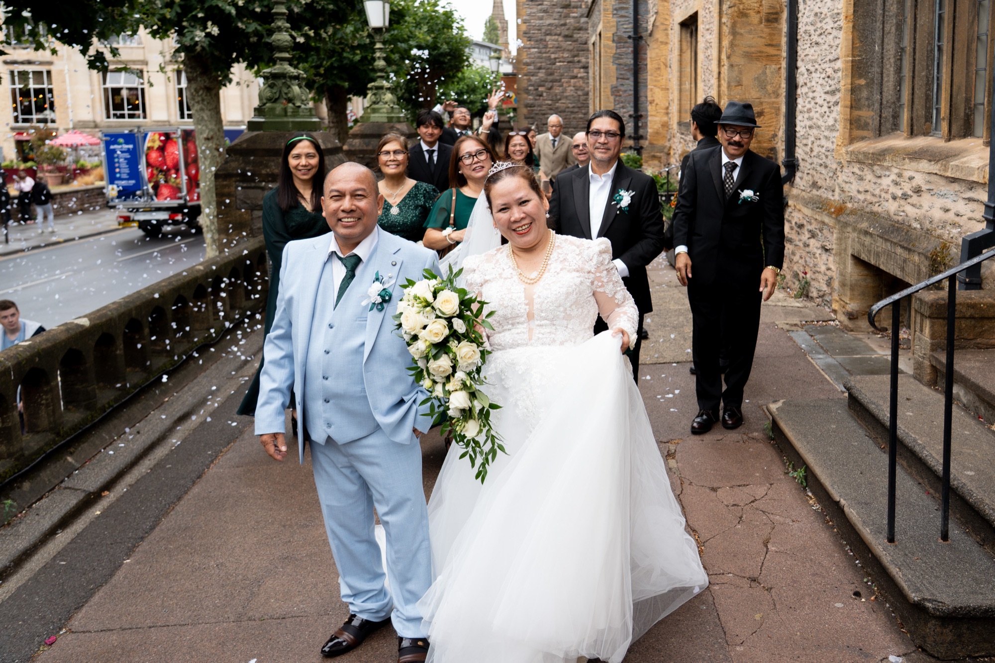 The newlyweds walking through confetti
