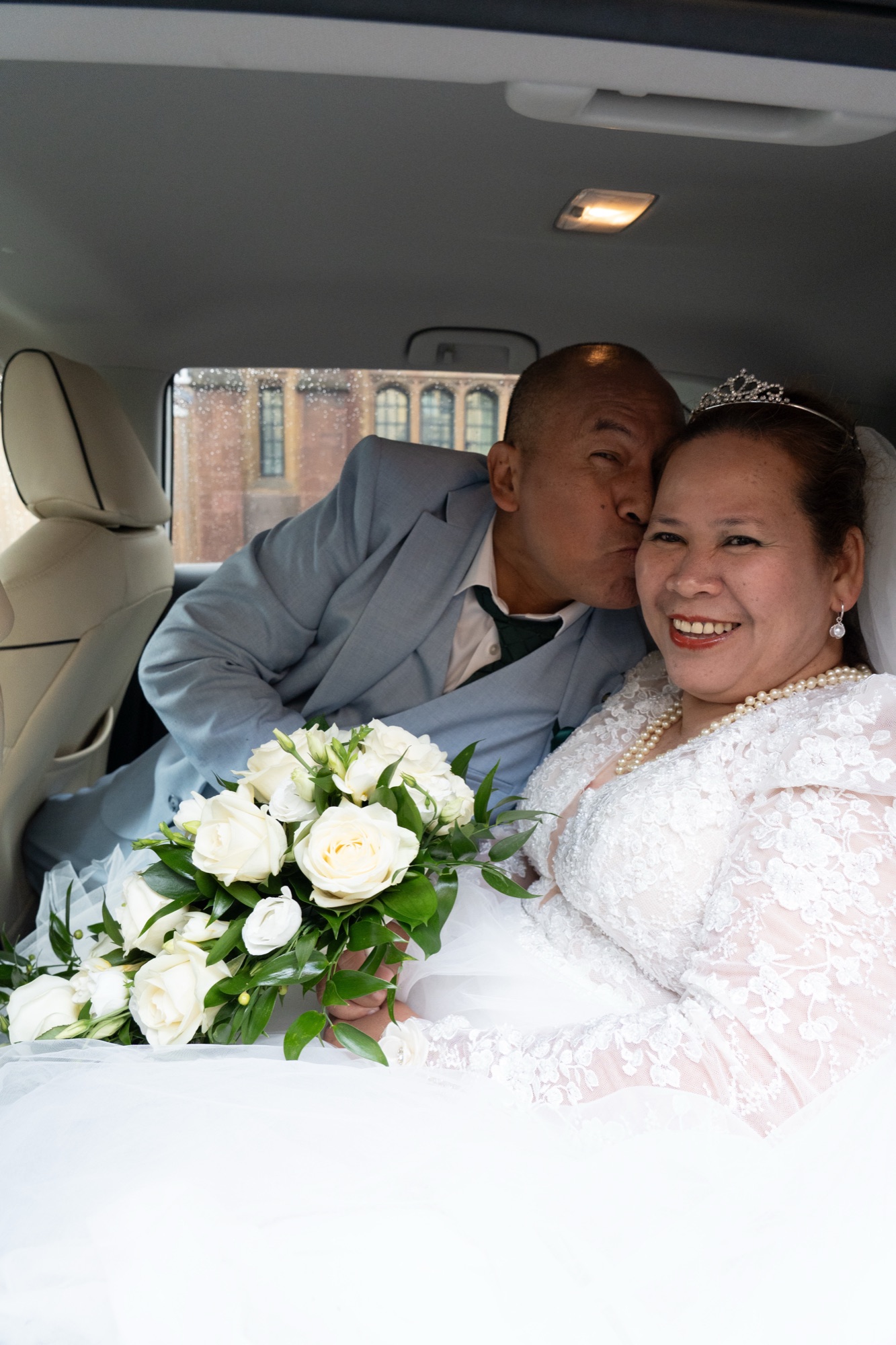 The newlyweds together in the wedding car